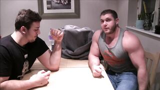 Hunks arm wrestle and show of their muscles 